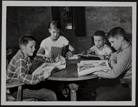 Scouts take time to study while at camp; (L to R) Paul Kincaid, Don Malone, Bobby Crown, and Joe Bales.