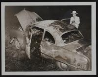 Fires - Mrs. Mildred Hitzman of KC - burned to death when she set her car afire. Leavenworth County Sheriff Arden Rhyne looks at burned car.
