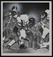 LHS Football vs. Wyandotte. (L to R) Doyle Shick; Jim Ragan; Junior Smith; Bob Craig; Stop Gilbert Wilson of Wyandotte.