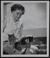 Shirley Rolin with cat and adopted skunk.