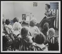 Children's storytelling at City Library - A. Loren Jones B. Marcia Alderson; Tommy Alderson; Lynn Keltz; Susan Alderson. F unidentified.