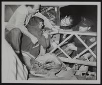 Auto Wreck - KU students Justin Cash (left) and Beldon Mills. Officers Bill Mooniau (left) and Rex Johnson.