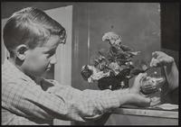 Mother&#39;s Day; Jack Dysart with plant for his mother.