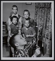 March of dimes - measure their height in dimes (L to R) Franklin Murphy, Jr; Sally Stough; Mitt Winter; Mark Edmonds; Fred Winter.