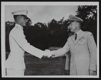 Cadet Riley R. Moore receives congratulations from Brigadier General Throckmorton.