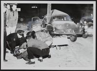 Auto Wrecks - (Probably) Carl Swain Anderson lifted to stretcher - patrolman Earl Harris at Left.