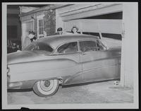 Auto Accidents - Nanette Evan&#39;s car rolls into garage door of Cooper Warren Mortuary.