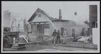 Fires - Tonganoxie - where three children died - Children of Mrs. and Mr. Richard Skaggs. (A) General view of rear of building. (B) Fred Needham looks over Skaggs bedroom. (C) Tonganoxie, Linwood and Basehor firemen and front of building in Downtown. (D) view of front of building.