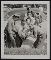 Auto Wreck- Mrs. Karl Higgins of KCMO. (L to R) Trooper Dee Montgomery; Oscar Rumsey; Jim McClure; Fred Cooper; Carl Grey, Jr