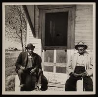 Reverend Joesph D.Wilson and Jerry Scruggs sitting in front of Nicodemus post office