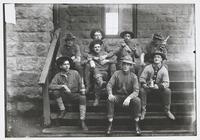A Battery Soldiers Sitting on Fort Riley Steps Holding Whisky Bottles