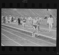 Three athletes running a relay race