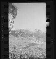 Athlete with K and 38 on his tank top running out of the water hazard of the steeplechase
