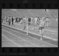 Two athletes finishing a relay race