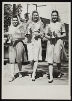 Three women walking down street