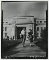 Two students walking out of Strong Hall