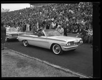 Homecoming Queen candidate riding in car