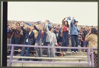 Football fans waving blue cloths
