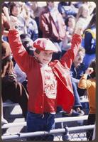 Young Boy With Arms Raised at the University of Kansas v. University of Oklahoma Game
