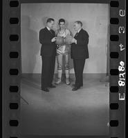 Basketball Coaches "Phog" Allen and James Naismith Holding Basketballsin Front of a University of Kansas Player