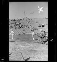 Woman in costume with a baton doing a back bend during a band performance