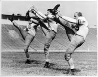 Three players practicing kicking