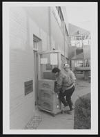 Students using book return machine at Engineering Library
